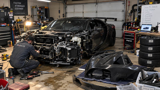 Illustration of a damaged exotic supercar being rebuilt in a modest garage with improvised tools, representing Mat Armstrong’s Bugatti rebuild.