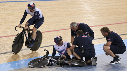 Track cyclists competing in a team sprint at an indoor velodrome, illustrating the dark arts and gamesmanship of sport.